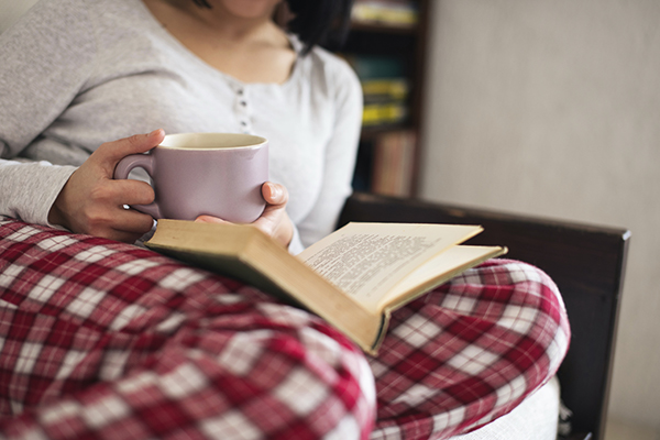 Woman In Pajamas Reading