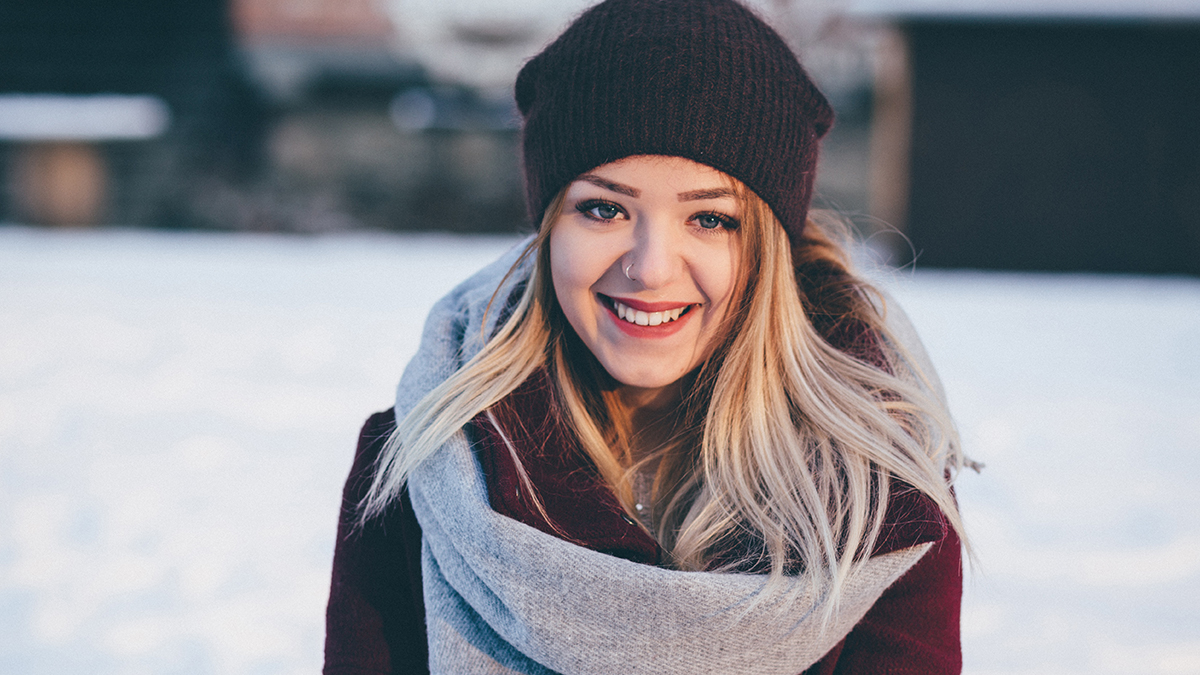 Girl in scarf and beanie outside in snow