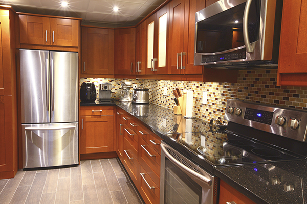 Kitchen with wood cabinets and a marble counter