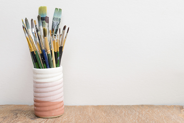 Paintbrushes in a glass on the table