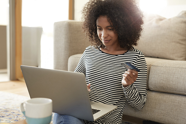 Woman shopping online with laptop and credit card