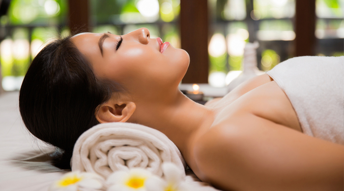 Woman getting a spa treatment with eyes closed and relaxed