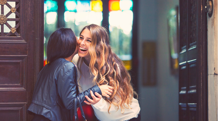 Woman greeting friend at the door