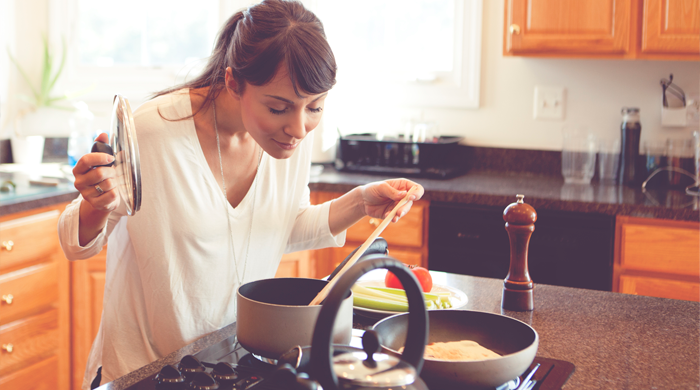 Woman cooking in kitchen alone