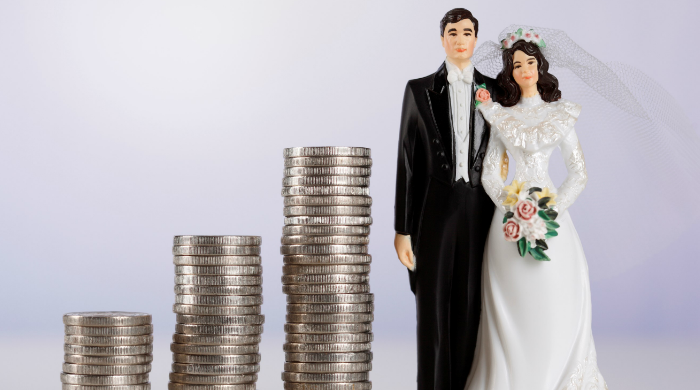 Stack of change next two bride and groom figurines