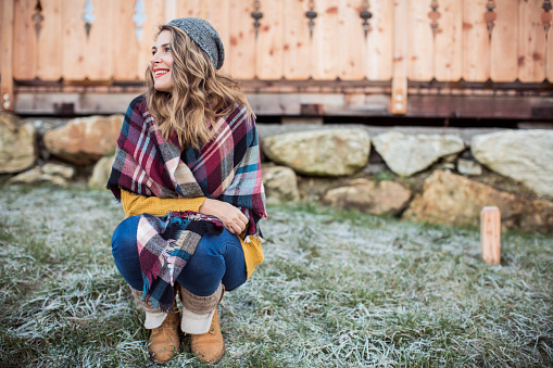 Woman outside wearing blanket scarf