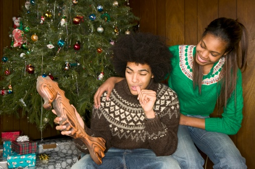 African American man receiving odd Christmas present
