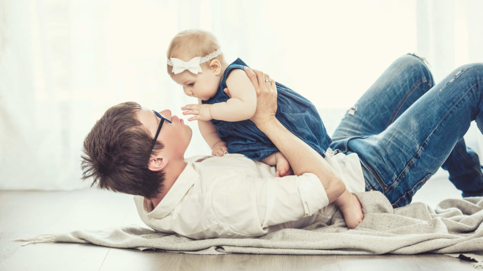 Dad playing with baby