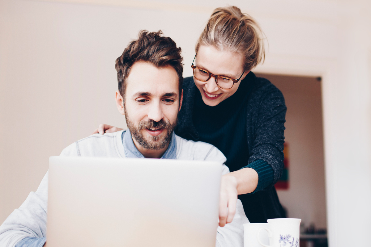 Man and woman looking at a laptop together