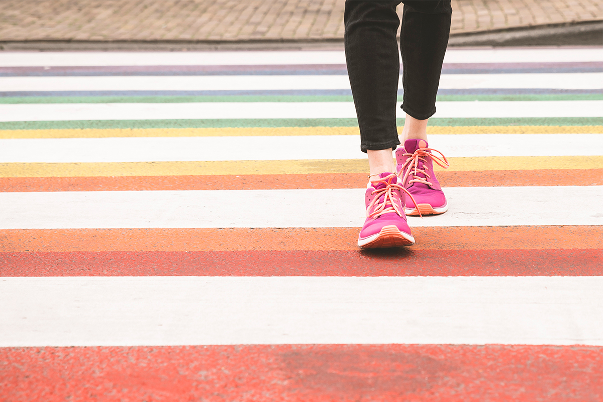 Walking on a rainbow crosswalk