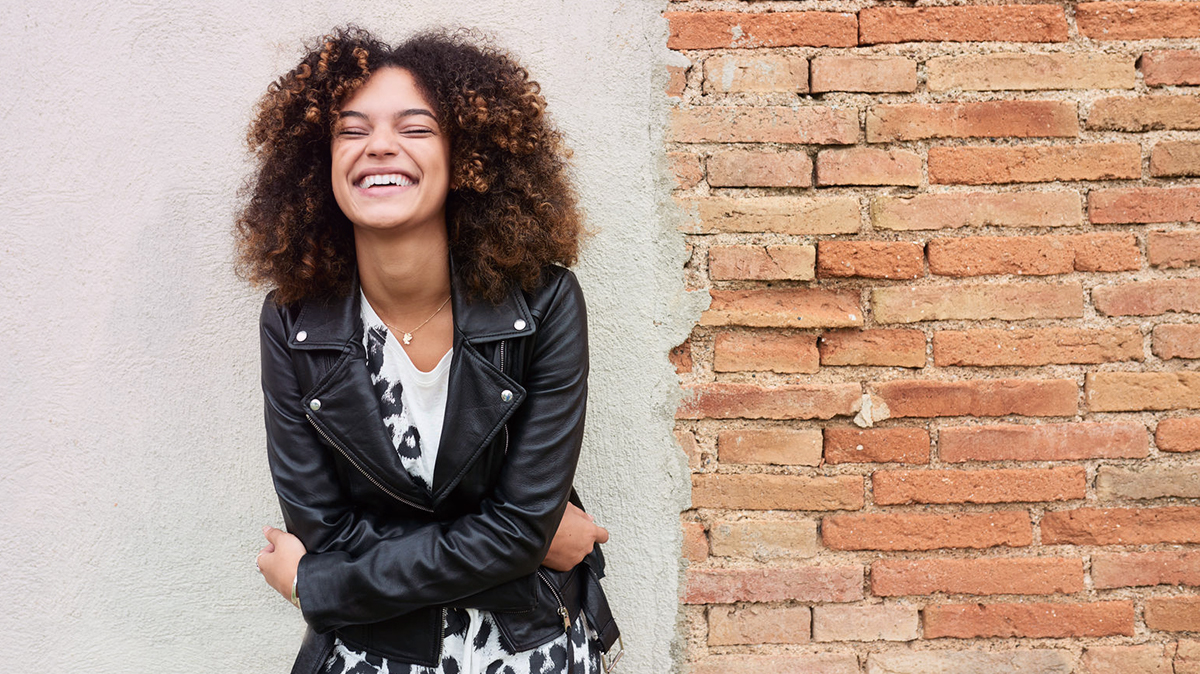 Women wearing a leather jacket laughing