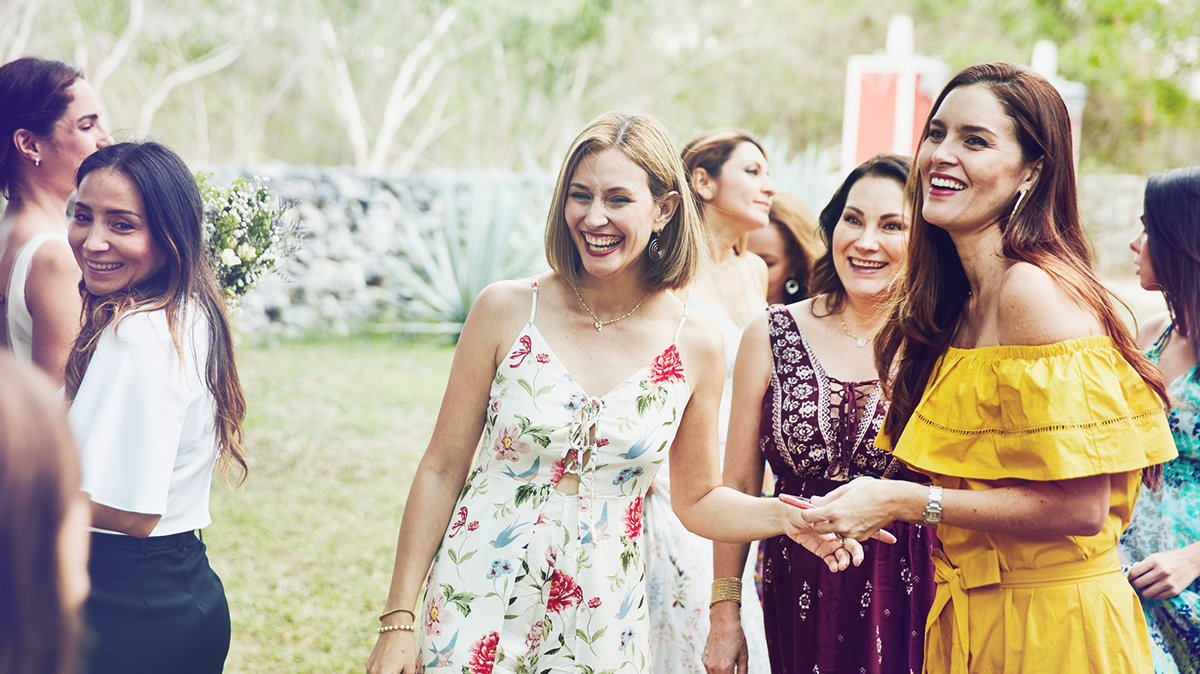 Women in dresses laughing