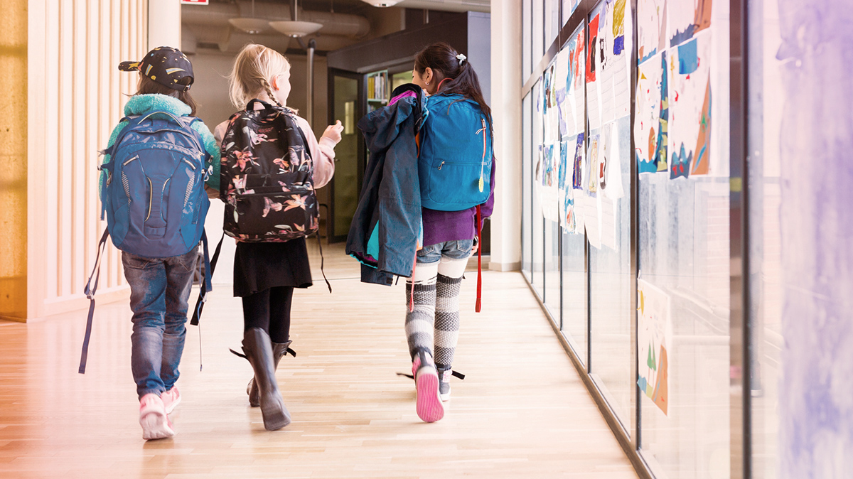 Young girls carrying backpacks