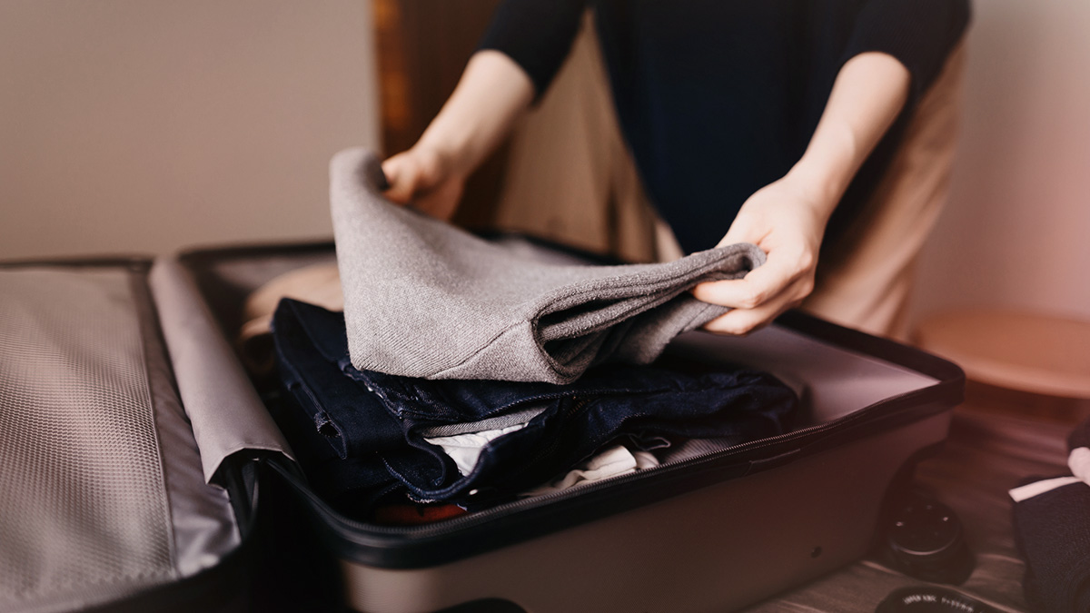 Person packing a suitcase