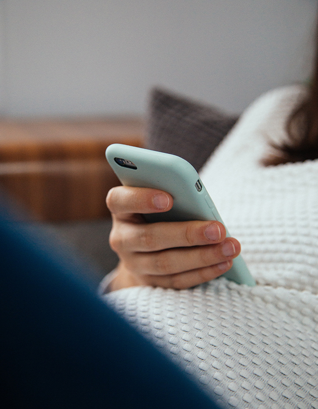 Pregnant woman using her phone
