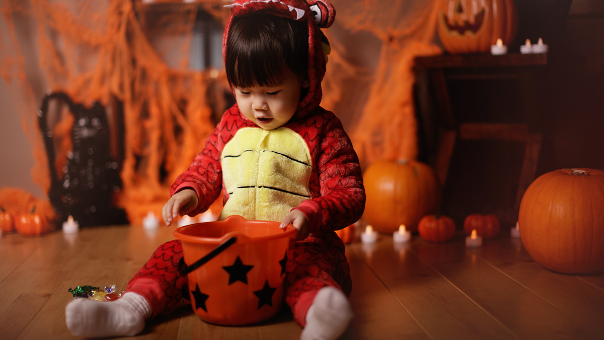 Baby in a dragon Halloween costume