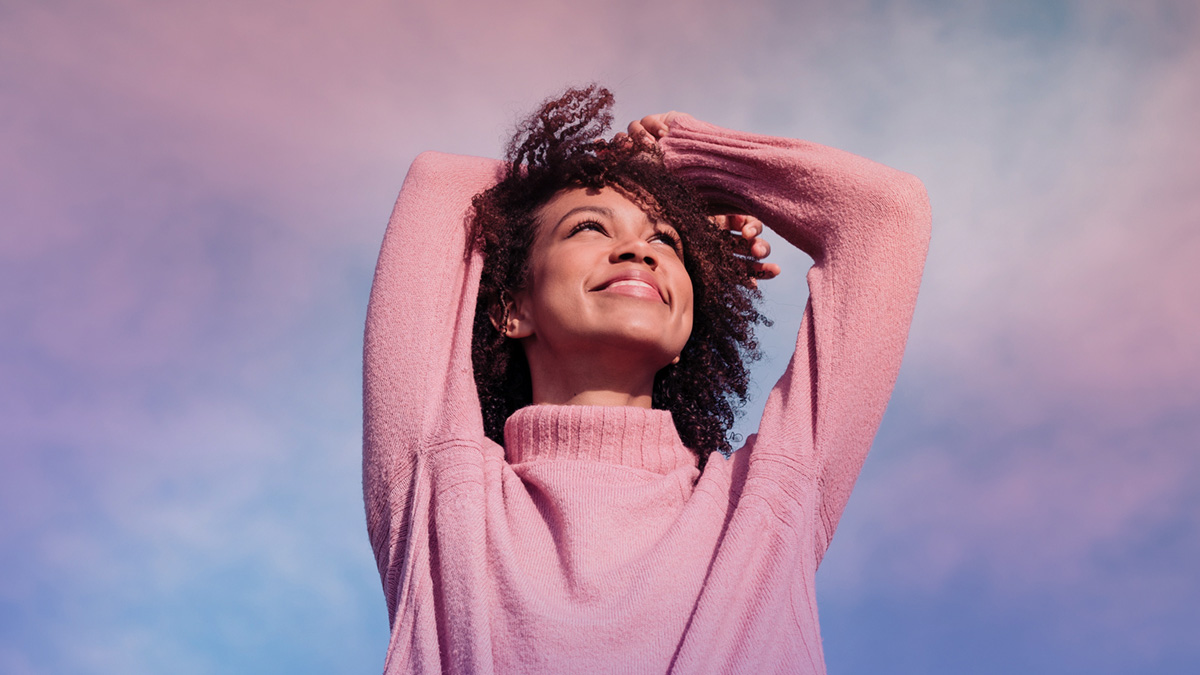 Girl beneath a cotton candy sky
