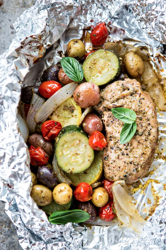 Good Life Eats PESTO PORK CHOP AND SUMMER VEGETABLE FOIL DINNERS