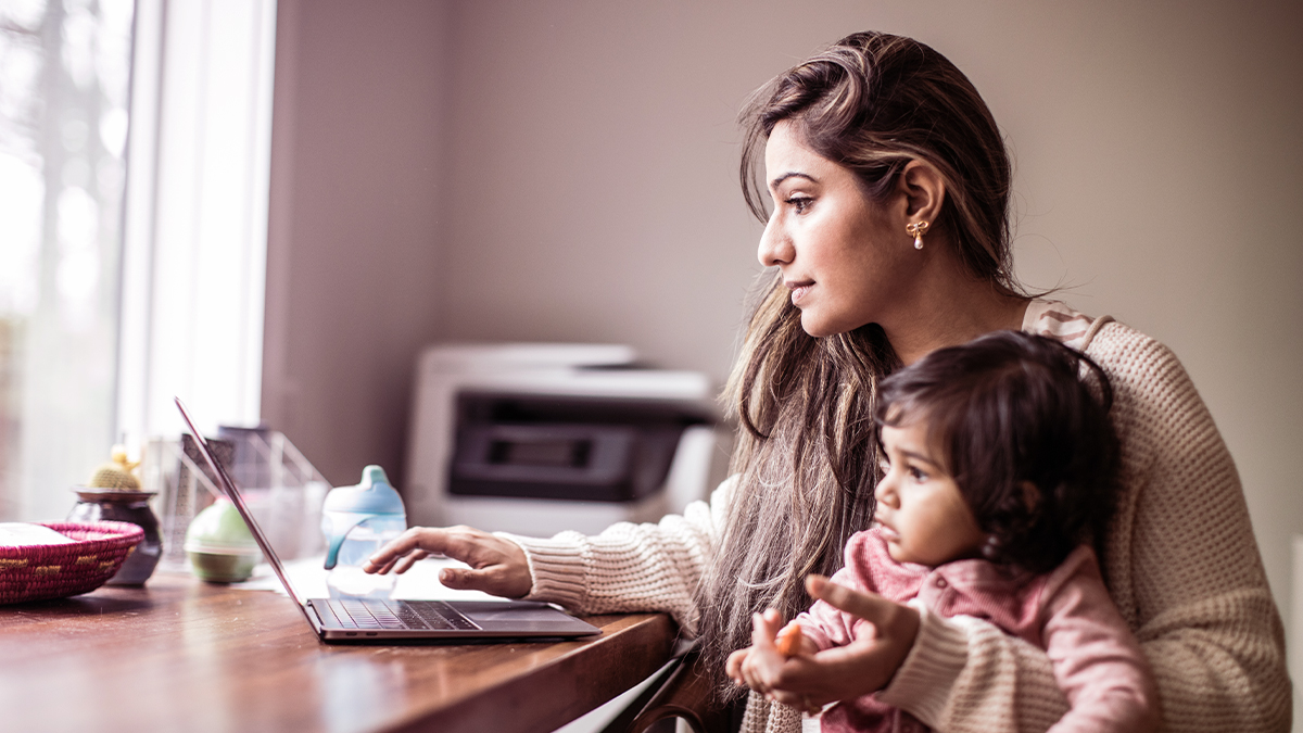 Mom on laptop with baby