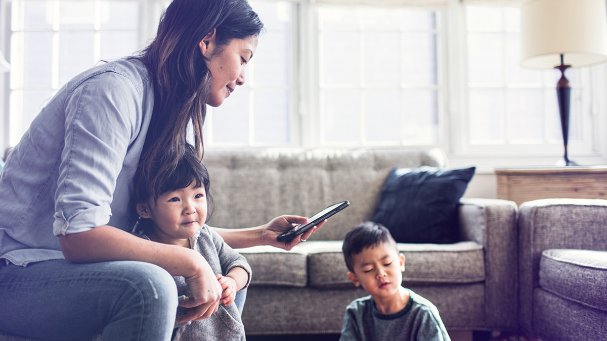 Woman on phone with kids