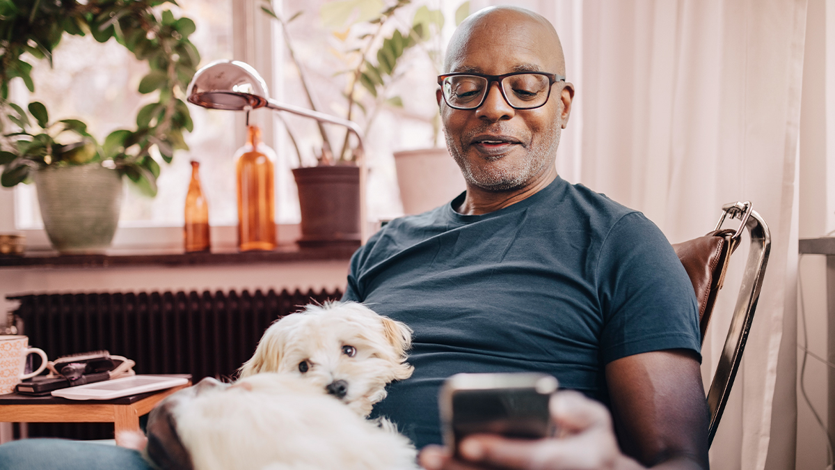 man on phone with dog
