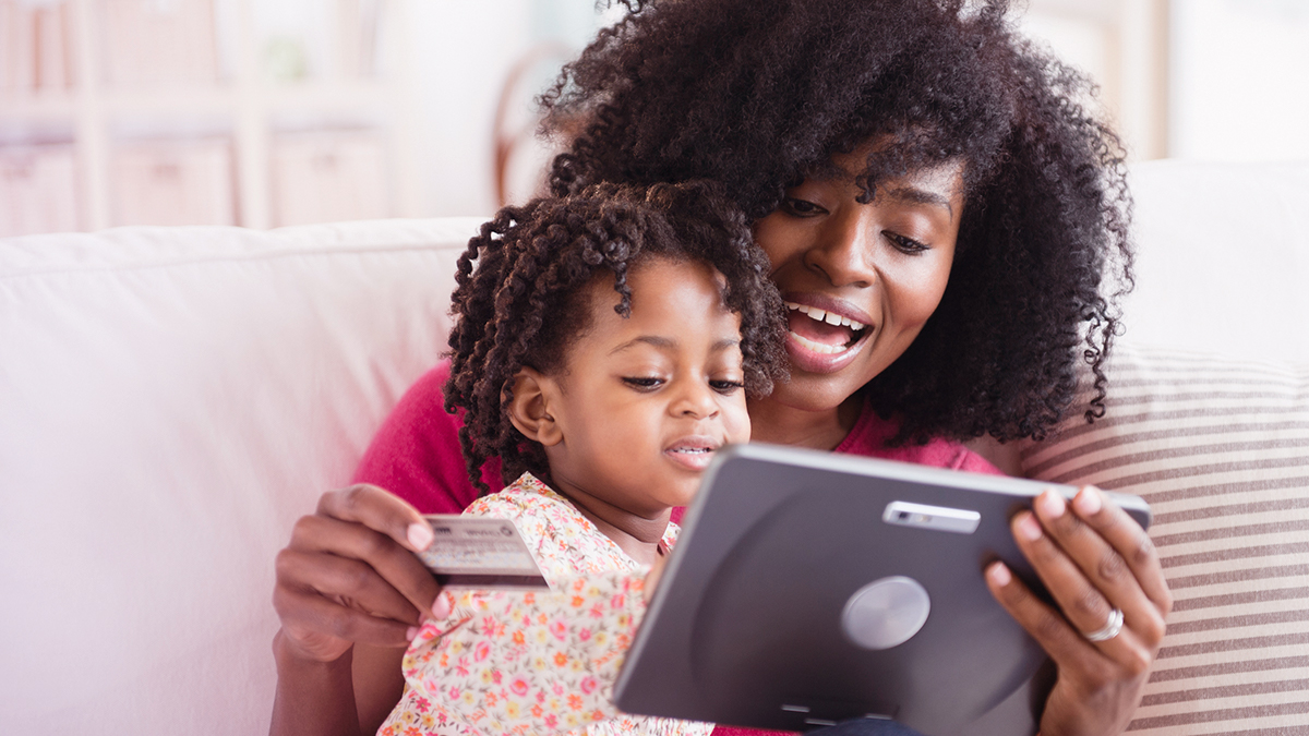 Woman on tablet holding kid