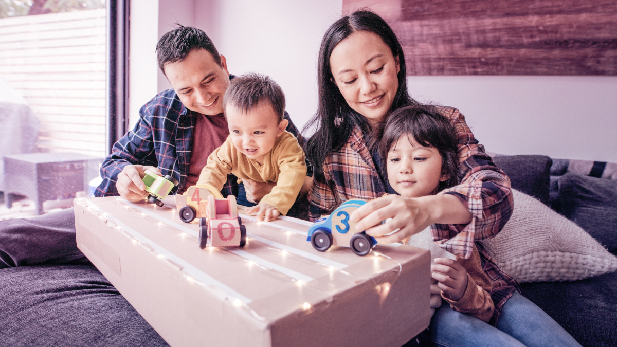 Family playing with toy cars