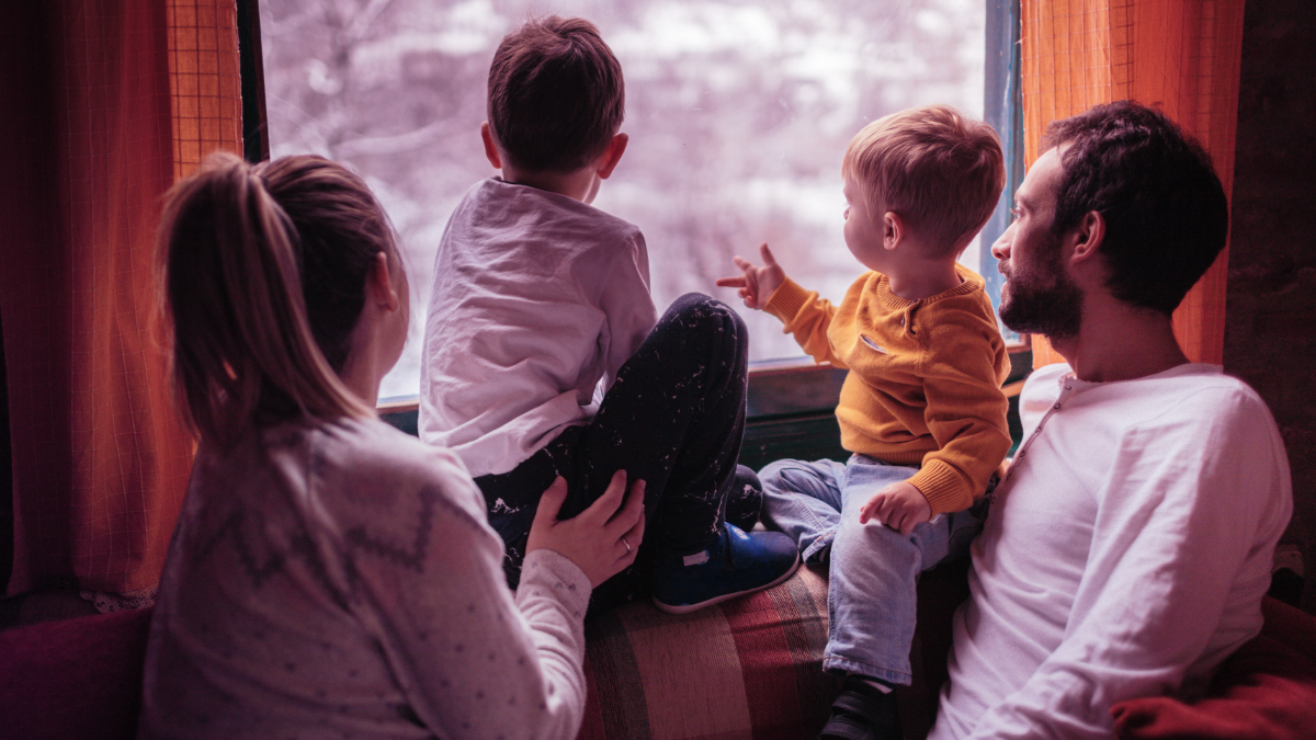 Family sitting in front of window