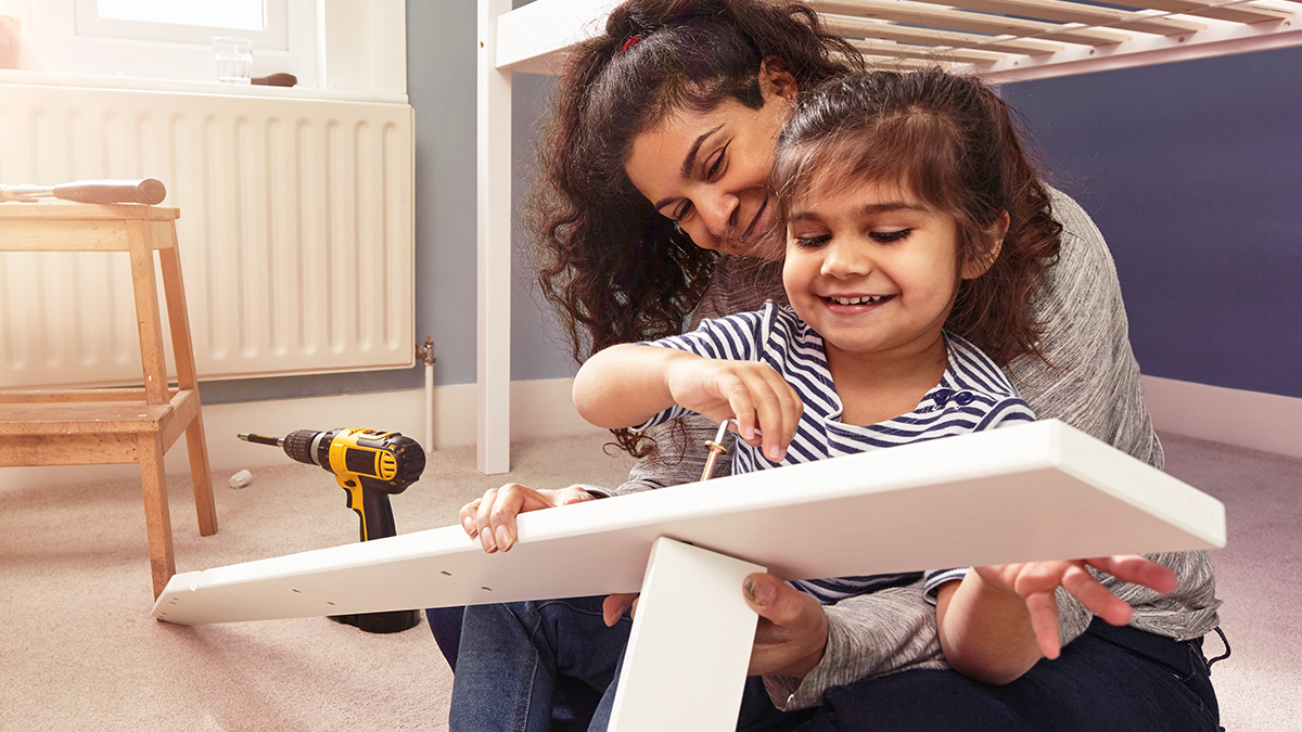Woman and daughter with a drill