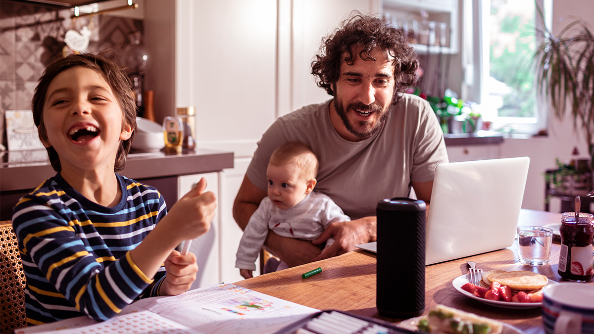 Family with laptop and speaker