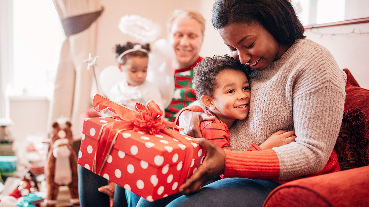 Mom hugging son with gift