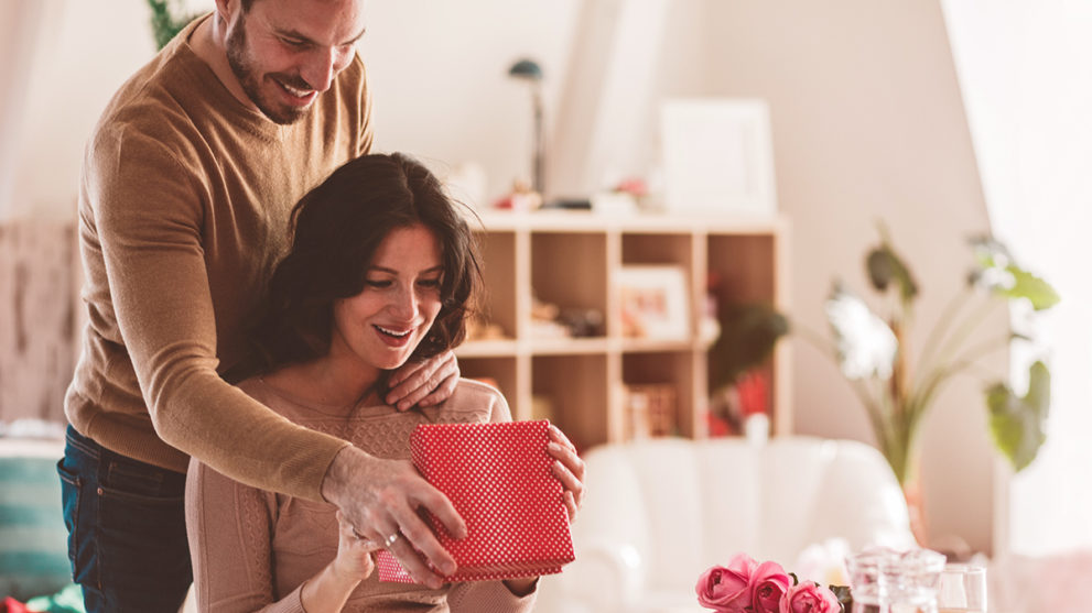 Couple opening gift