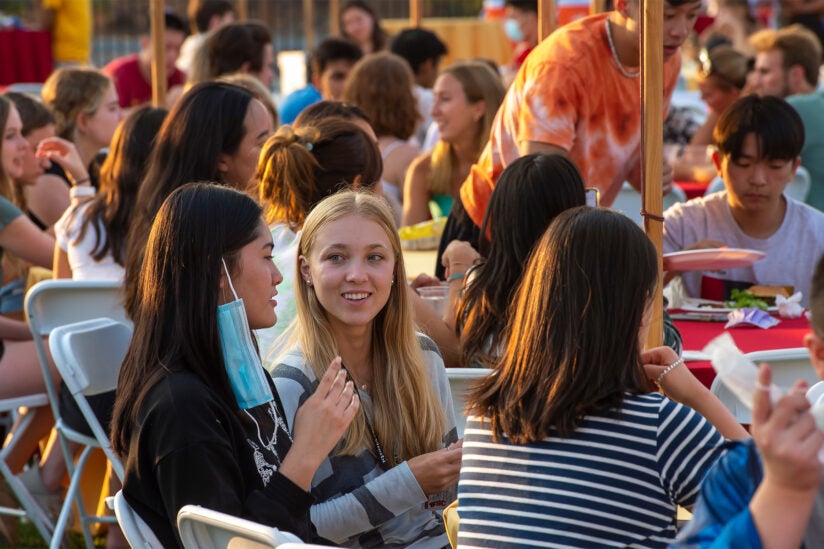 Students talking with each other at BBQ dinner