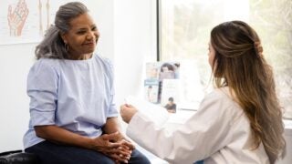 Woman in medical office with female clinician