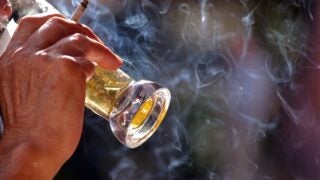 Older man drinking and smoking